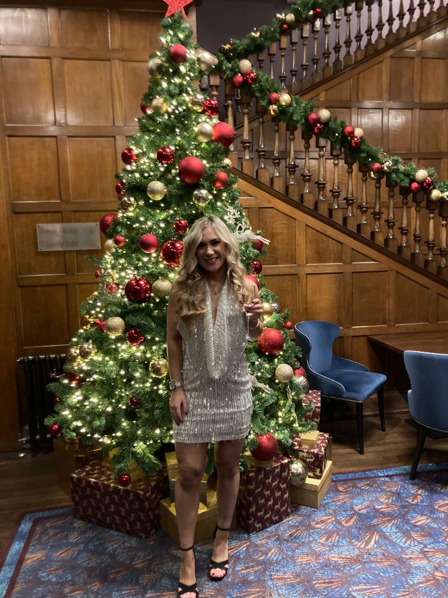Charlotte White in front of the tree