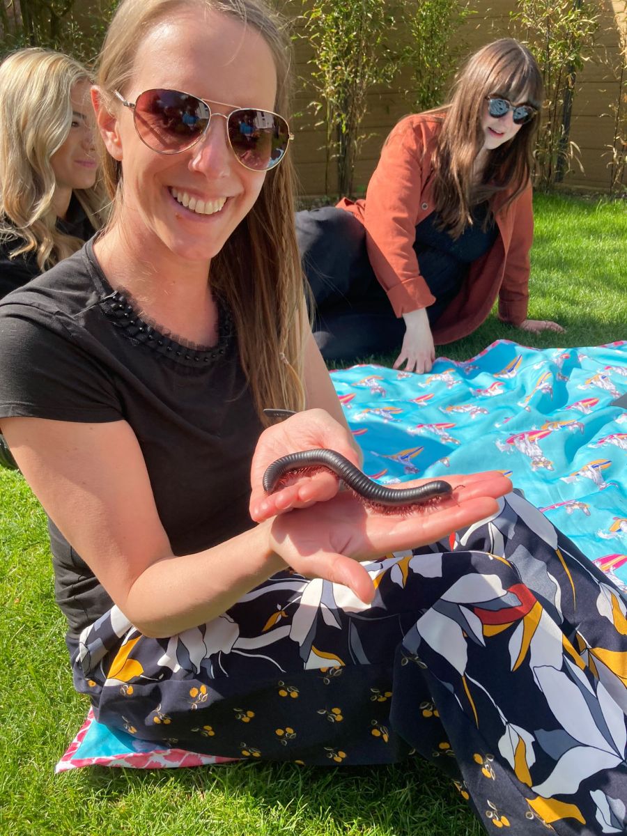 A woman holds a millipede in her hand